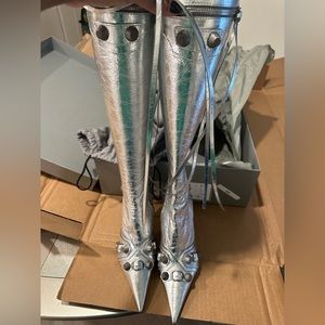 Metallized lambskin upper. Side zipper closure with Silver studs.